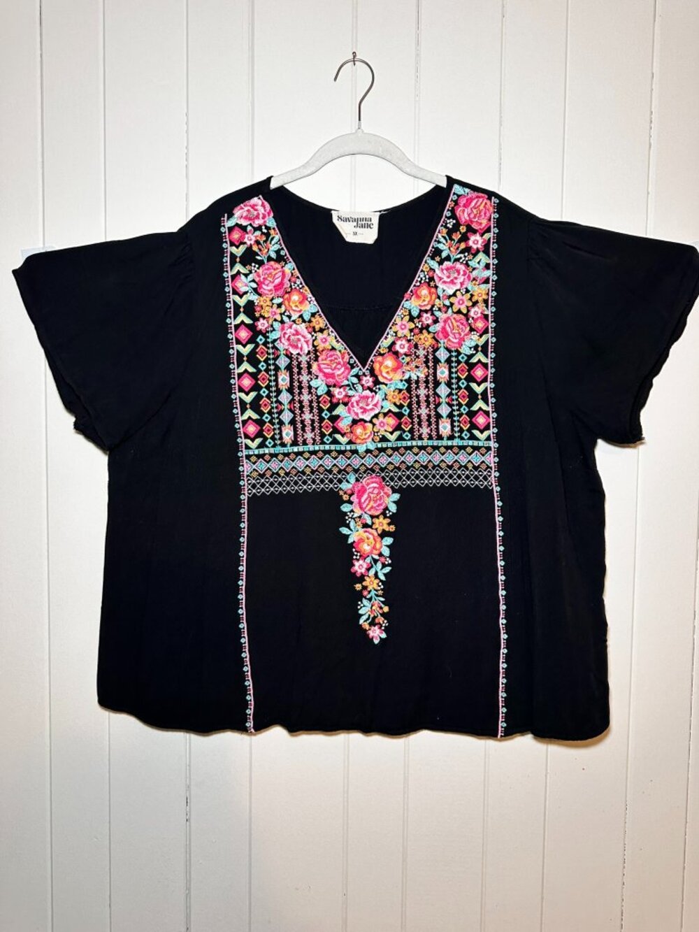 Savannah Jane blouse features vibrant pink and orange floral embroidery